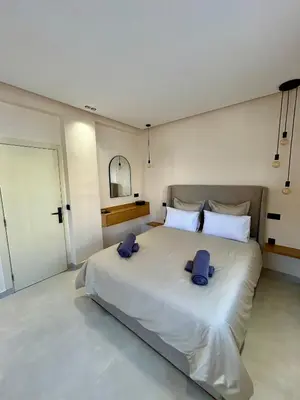 a bedroom with a large bed with two pillows on it at Appartement 2 chambres neuf Marjane Rte de Casa in Marrakech