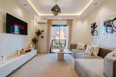 a living room with a couch and a table at Appartement Standing Marrakech Caricia in Marrakech
