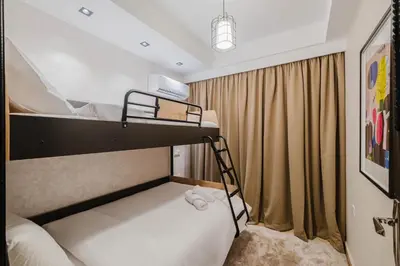 a bedroom with a bunk bed with a ladder at Appartement Standing Marrakech Caricia in Marrakech