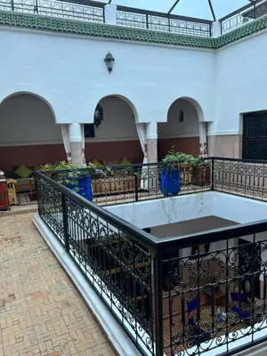a balcony in a building with a table on it at RIAD Dar Aïlen Médina in Marrakech