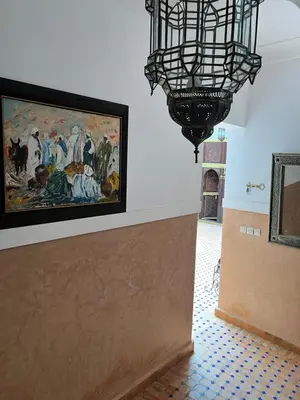 a room with a painting on the wall and a chandelier at RIAD Dar Aïlen Médina in Marrakech
