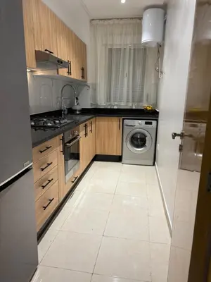 a kitchen with a sink and a washing machine at Appartement Targa Marrakech in Marrakech