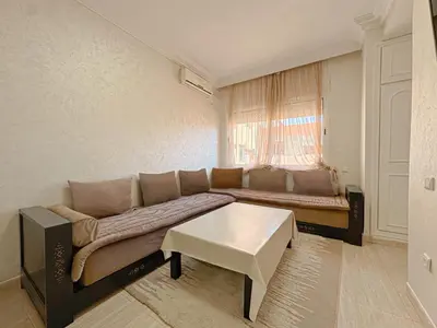 a living room with a couch and a table at Studio Elégant Gueliz in Marrakech