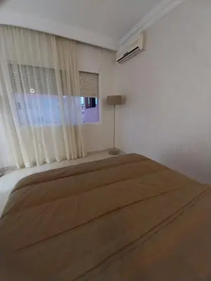 a bedroom with a large bed with a window at Studio Elégant Gueliz in Marrakech
