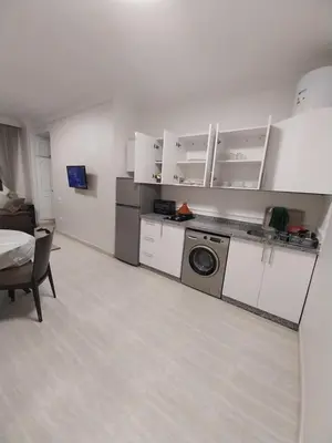 a kitchen with a washing machine in a room at Studio Elégant Gueliz in Marrakech