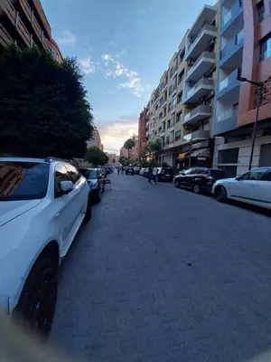 a white car parked on the side of a street at Studio Elégant Gueliz in Marrakech