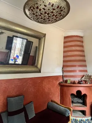a living room with a mirror and a couch at Riad Dar Aïlen Medina in Marrakech