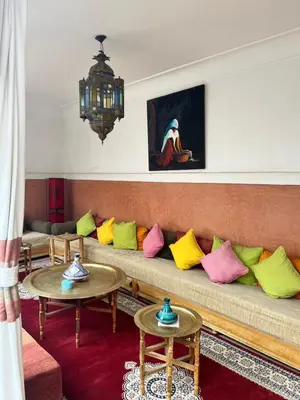 a living room with a couch with colorful pillows at Riad Dar Aïlen Medina in Marrakech
