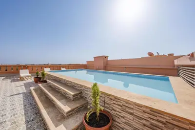 a swimming pool on the roof of a building at Appartment - Kasbel 2 - Pools & Spa & Gym Club in Marrakech