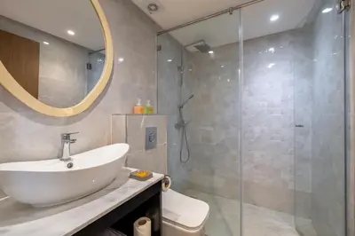 a bathroom with a sink and a shower at Appartment - Kasbel 2 - Pools & Spa & Gym Club in Marrakech