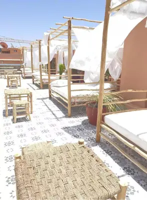 a room with several beds and a rug on the floor at Appartment - Kasbel 2 - Pools & Spa & Gym Club in Marrakech