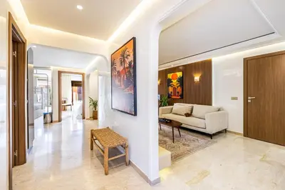 a living room with a couch and a table at Appartment - Kasbel 2 - Pools & Spa & Gym Club in Marrakech