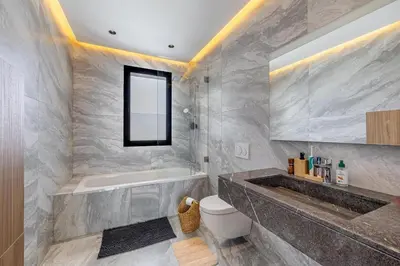 a bathroom with a tub and a toilet and a sink at Villa Alfa Élégance, Calme & Confort Premium in Marrakech