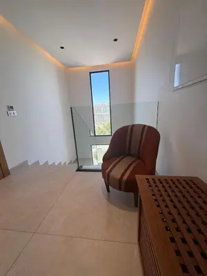 a living room with a chair and a window at Villa Alfa Élégance, Calme & Confort Premium in Marrakech