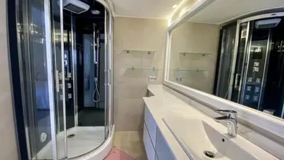 a bathroom with a sink and a shower and a mirror at Grand duplex Palmeraie in Marrakech