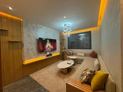 a living room with a couch and a tv at Elite garden Stylish Unique Appartement in Marrakech