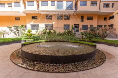 a water fountain in front of a building at Elite garden Stylish Unique Appartement in Marrakech