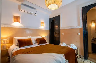 a bedroom with a large bed in a room at Riad Bloom in Marrakech