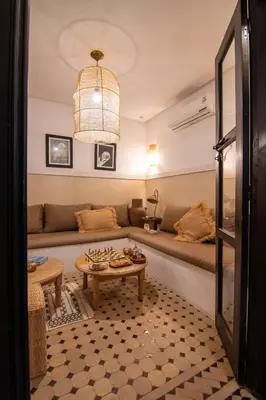 a living room with a couch and a table at Riad Bloom in Marrakech
