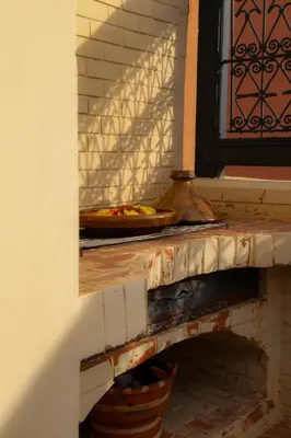 a fireplace with a pizza on top of it at Riad Bloom in Marrakech