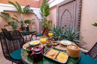 a table with breakfast foods and drinks on it at Riad Bloom in Marrakech