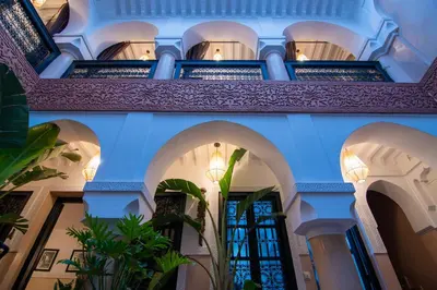 a building with blue walls and arches at Riad Bloom in Marrakech