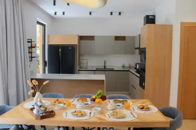 a kitchen with a wooden table with food on it at Villa de prestige avec piscine privée in Marrakech