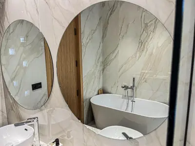 a bathroom with a tub and a sink and a mirror at Villa de prestige avec piscine privée in Marrakech