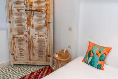 a bedroom with a bed with a pillow and a table at Riad Prive in Marrakech
