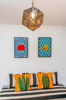 a room with a couch with colorful pillows and a chandelier at Riad Prive in Marrakech