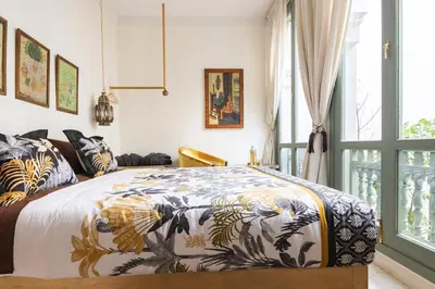 a bedroom with a king sized bed with a colorful blanket at Riad Koubba in Marrakech