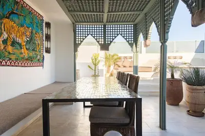 a dining room with a table and chairs at Riad Koubba in Marrakech
