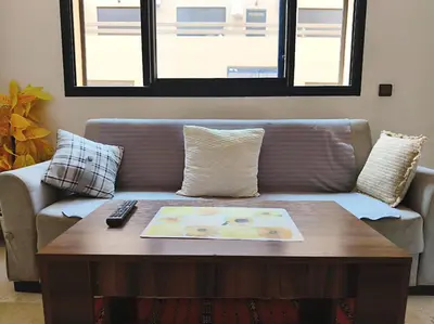 a living room with a couch and a coffee table at Hypercenter Comfy apartment Marrakech pool in Marrakech