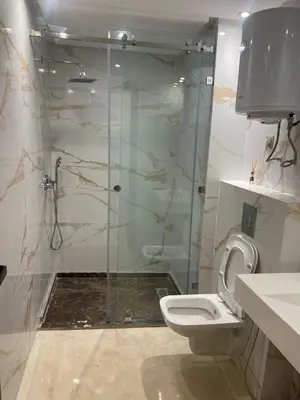 a bathroom with a shower and a toilet at City Luxe Studio in Marrakech