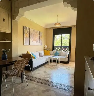 a living room with a couch and a table at Welcome to your Stylish Atlas View Apartment in Marrakech