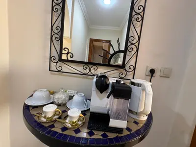 a coffee maker on a table with a mirror at Appartement de luxe dans le centre de Marrakech in Marrakech