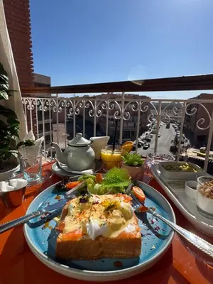 a plate of food on a table on a balcony at Appartement de luxe dans le centre de Marrakech in Marrakech