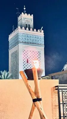 a large building with a clock tower in the background at Riad EL Mouloudi in Marrakech