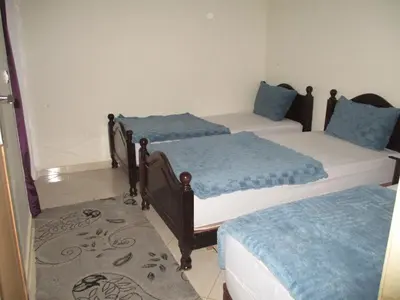 a bedroom with two beds with blue pillows at Joli spacieux apparrement in Marrakech