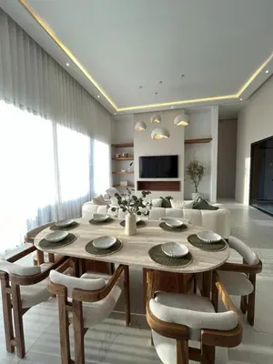 a living room with a dining table and a couch at Villa Signature in Marrakech
