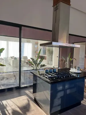a kitchen with a stove top oven in a room at Villa Signature in Marrakech