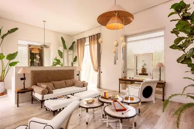 a living room with a couch and tables at The Source Hotel Music & Spa in Marrakech