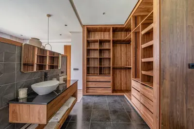 a bathroom with a sink and wooden cabinets at Villa Kniza Luxury Stay, Courtyard, Pool and View in Marrakech