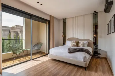a bedroom with a bed and a large window at Villa Kniza Luxury Stay, Courtyard, Pool and View in Marrakech
