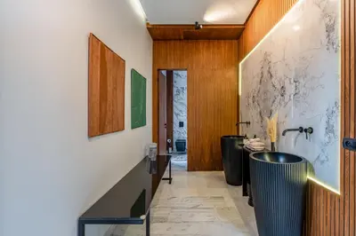 a hallway with a bathroom with a sink and a tub at Villa Kniza Luxury Stay, Courtyard, Pool and View in Marrakech