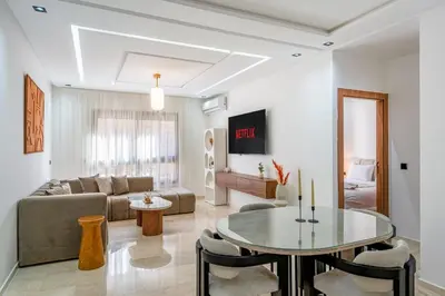 a living room with a couch and a table at Le Sunset - Menara Garden - Piscine - Balcon in Marrakech