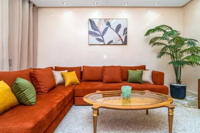 a living room with a couch and a table at Appart 2Ch Centre Marrakech in Marrakech