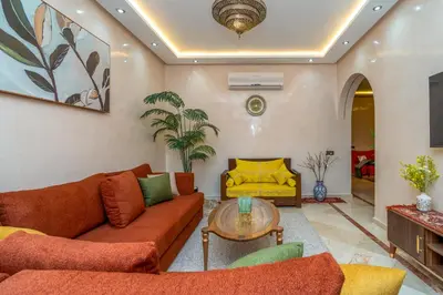 a living room with a couch and a table at Appart 2Ch Centre Marrakech in Marrakech