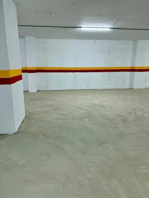 an empty parking garage with orange and white walls at Lovely condo Marrakech city center terrasse garage in Marrakech