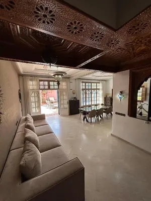 a large living room with couches and a table at Villa in marrakech city center with heated pool and breakfast inclued in Marrakech